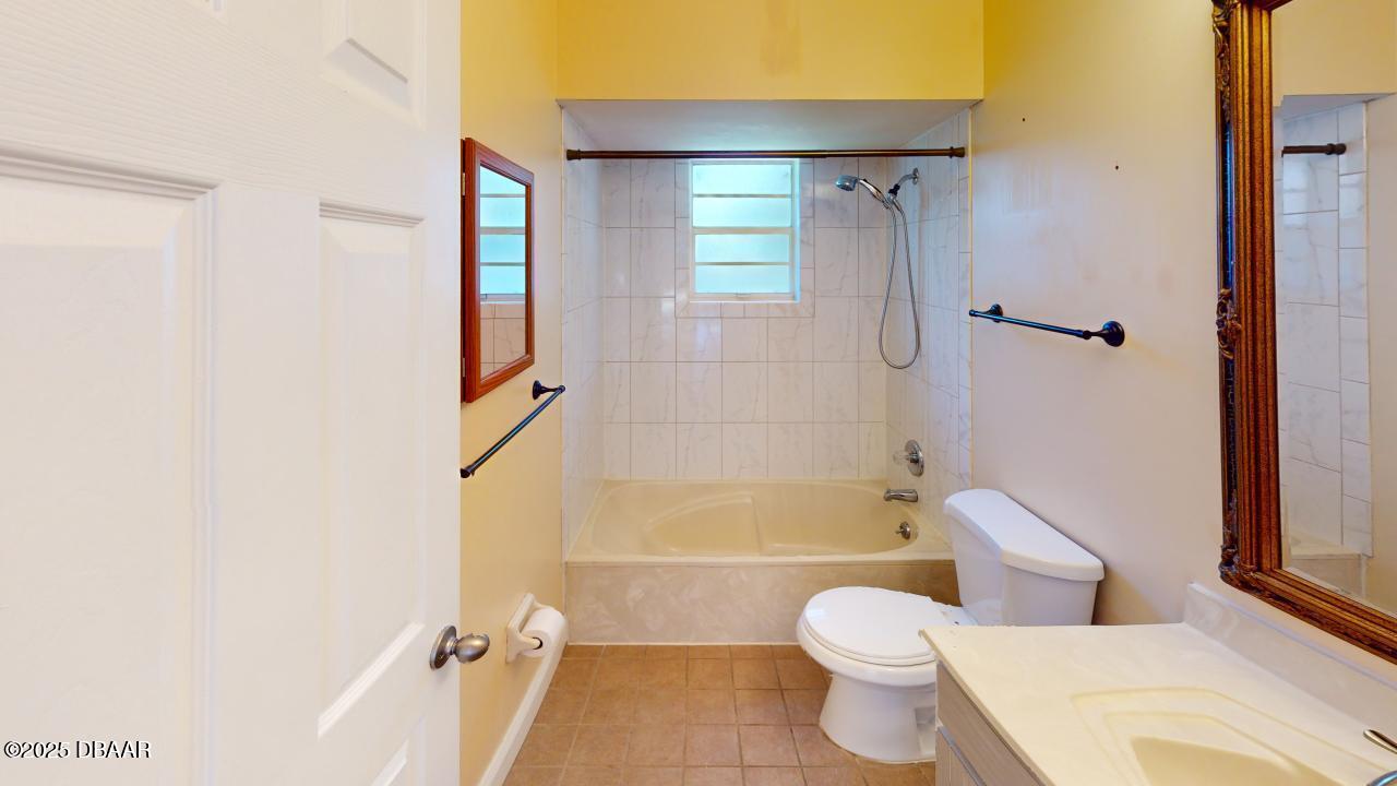 2219 Umbrella Tree Drive Edgewater, FL 32141 - Photo 16 of 22 a bathroom with a toilet and shower