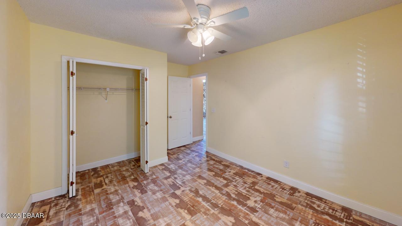 2219 Umbrella Tree Drive Edgewater, FL 32141 - Photo 18 of 22 a view of an empty room and chandelier fan