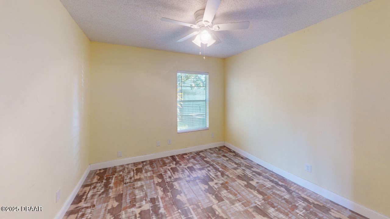 2219 Umbrella Tree Drive Edgewater, FL 32141 - Photo 19 of 22 an empty room with windows and fan