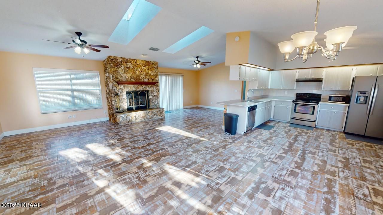 2219 Umbrella Tree Drive Edgewater, FL 32141 - Photo 3 of 22 a view of a kitchen with a stove cabinets and a fireplace