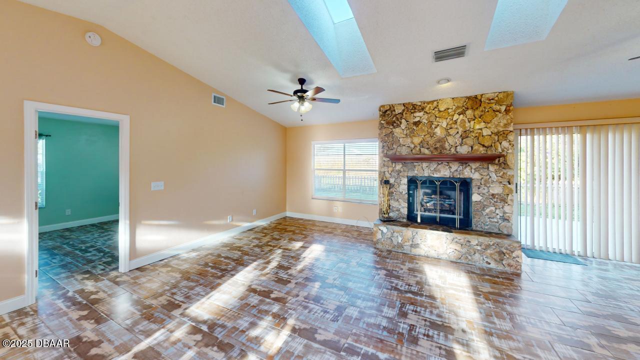 2219 Umbrella Tree Drive Edgewater, FL 32141 - Photo 6 of 22 a view of an empty room with a fireplace and a window
