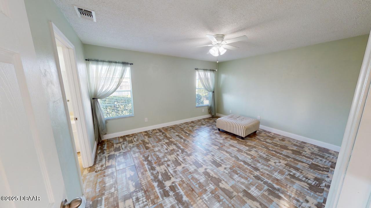2219 Umbrella Tree Drive Edgewater, FL 32141 - Photo 9 of 22 a view of a livingroom with wooden floor and window