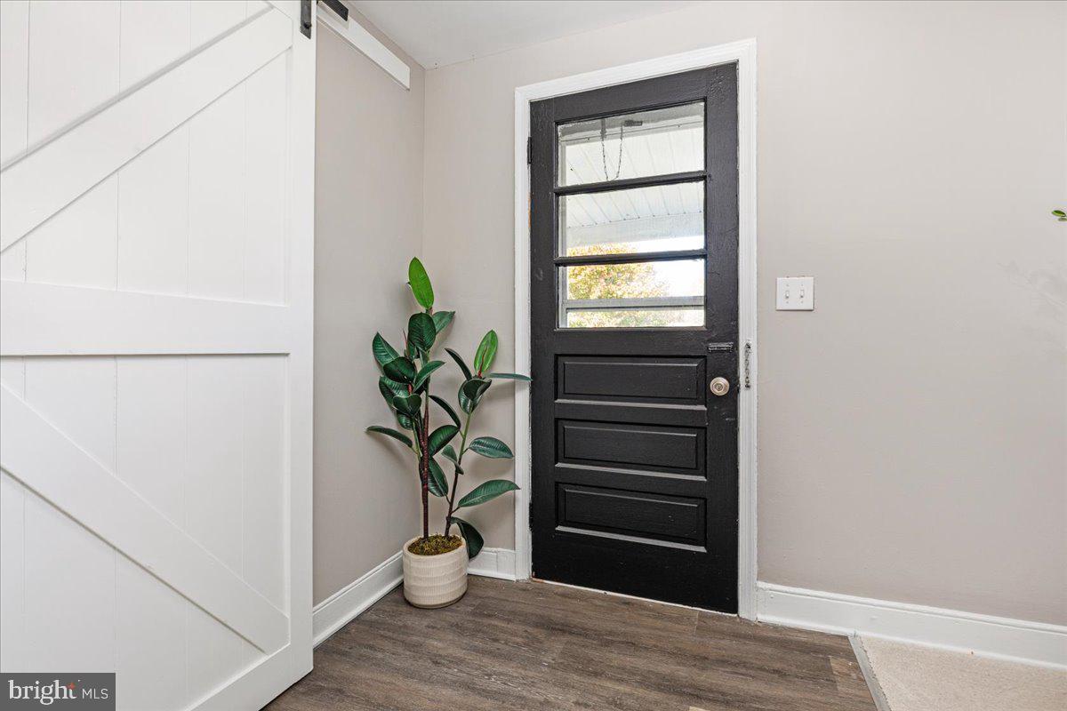 13886 Crest Hill Road Flint Hill, VA 22627 - Photo 3 of 45 a view of a hallway with wooden floor and a potted plant