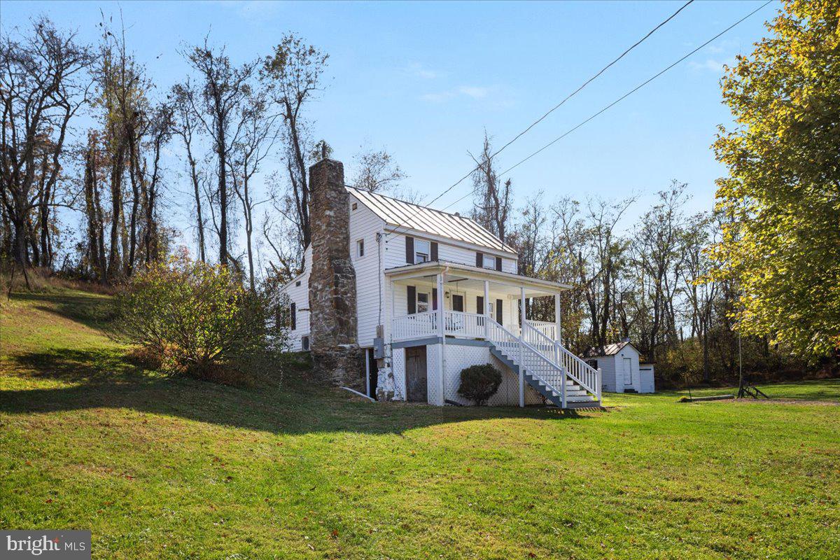 13886 Crest Hill Road Flint Hill, VA 22627 - Photo 33 of 45 a view of a house with a big yard and large trees