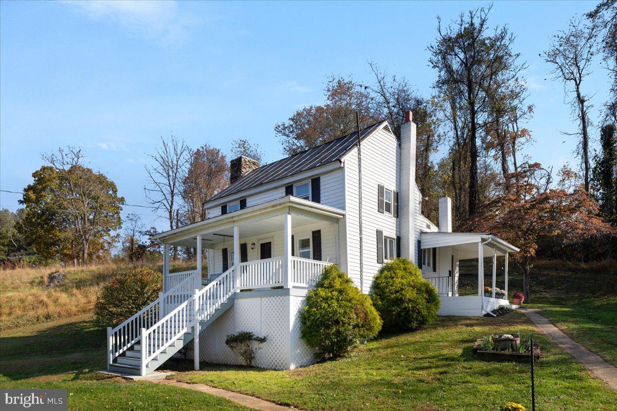 13886 Crest Hill Road Flint Hill, VA 22627 - Photo 34 of 45 a front view of a house with a garden and trees
