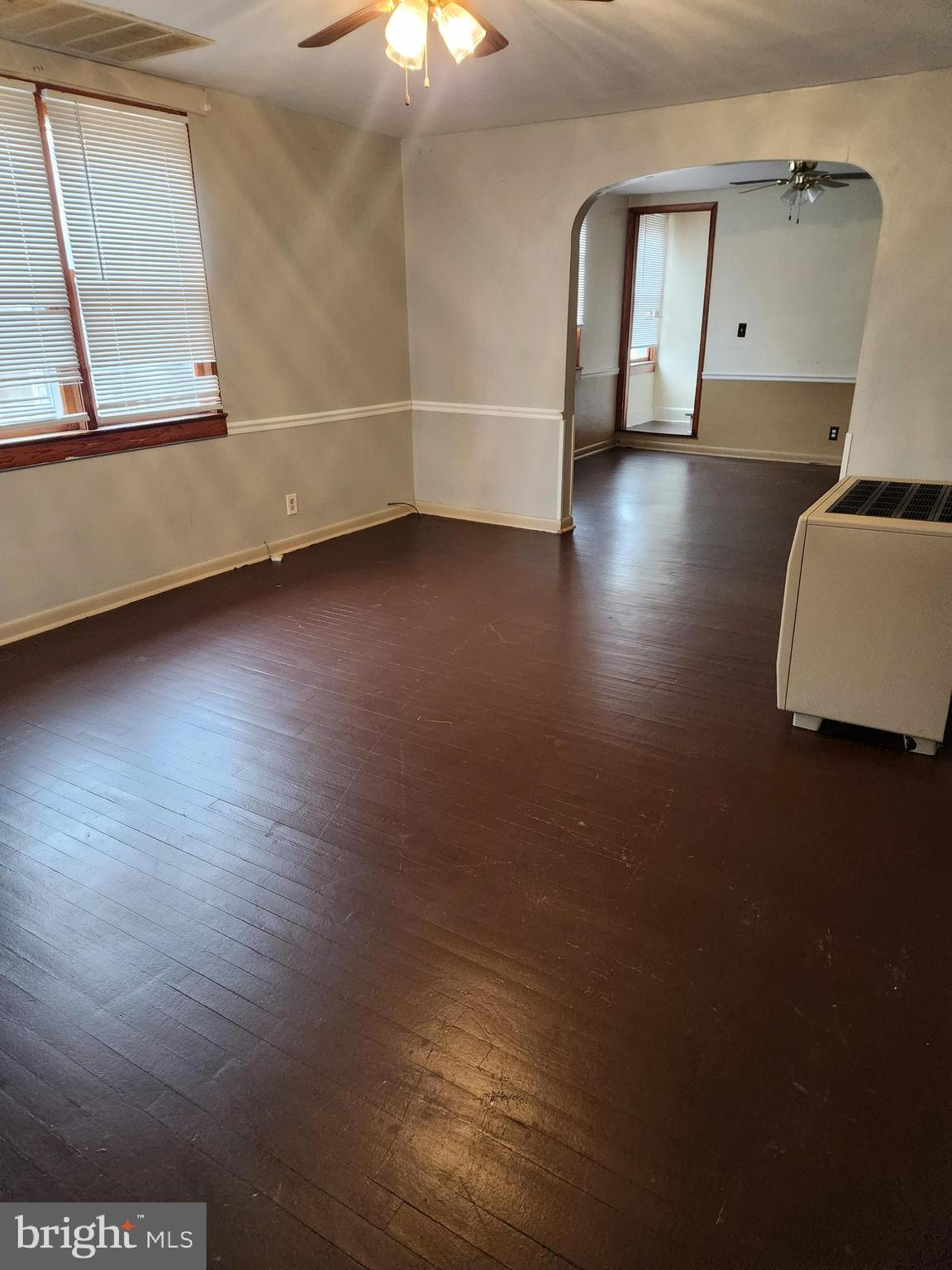 59 Gilmore Street Keyser, WV 26726 - Photo 2 of 13 an empty room with wooden floor and windows