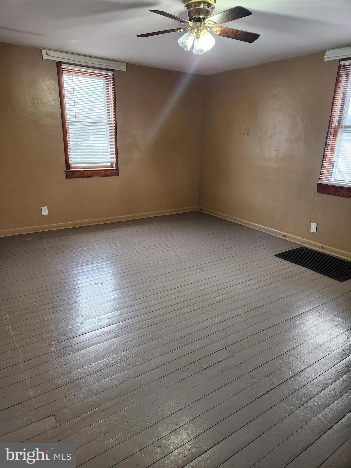 59 Gilmore Street Keyser, WV 26726 - Photo 9 of 13 an empty room with wooden floor and windows