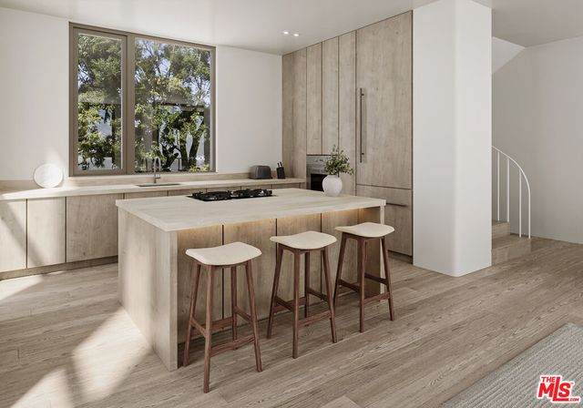 an empty room with wooden floor and plant