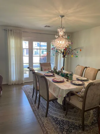 a view of a dining room with furniture and chandelier