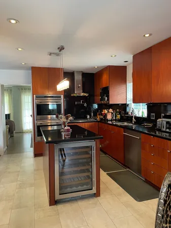 a kitchen with stainless steel appliances granite countertop a stove a sink and a refrigerator
