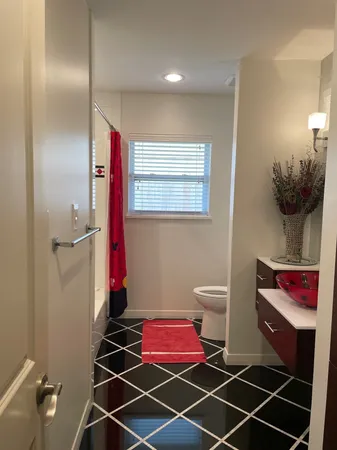 a bathroom with a toilet and a shower