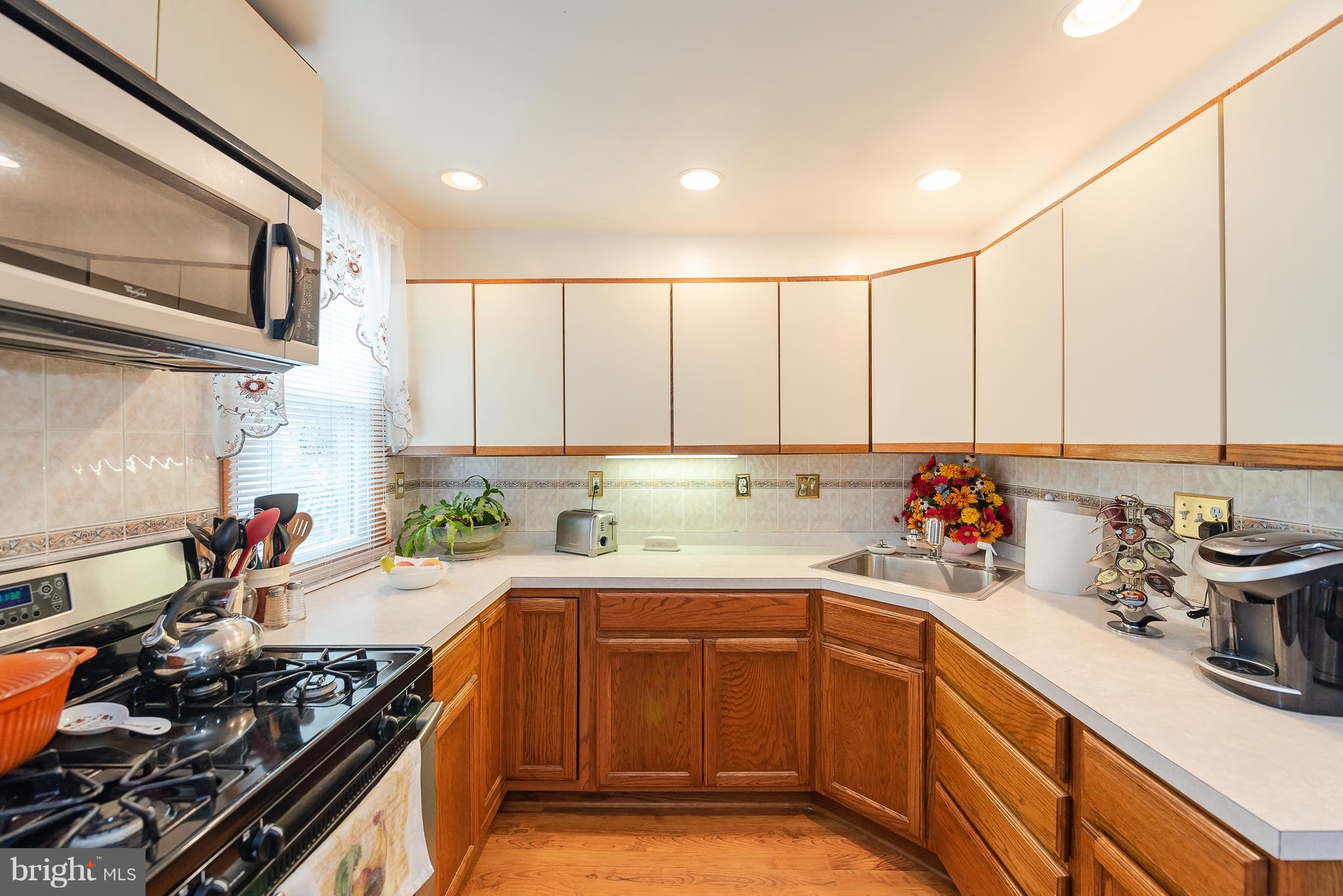 8238 Northview Road Baltimore, MD 21222 - Photo 24 of 42 a kitchen with a sink a stove and cabinets