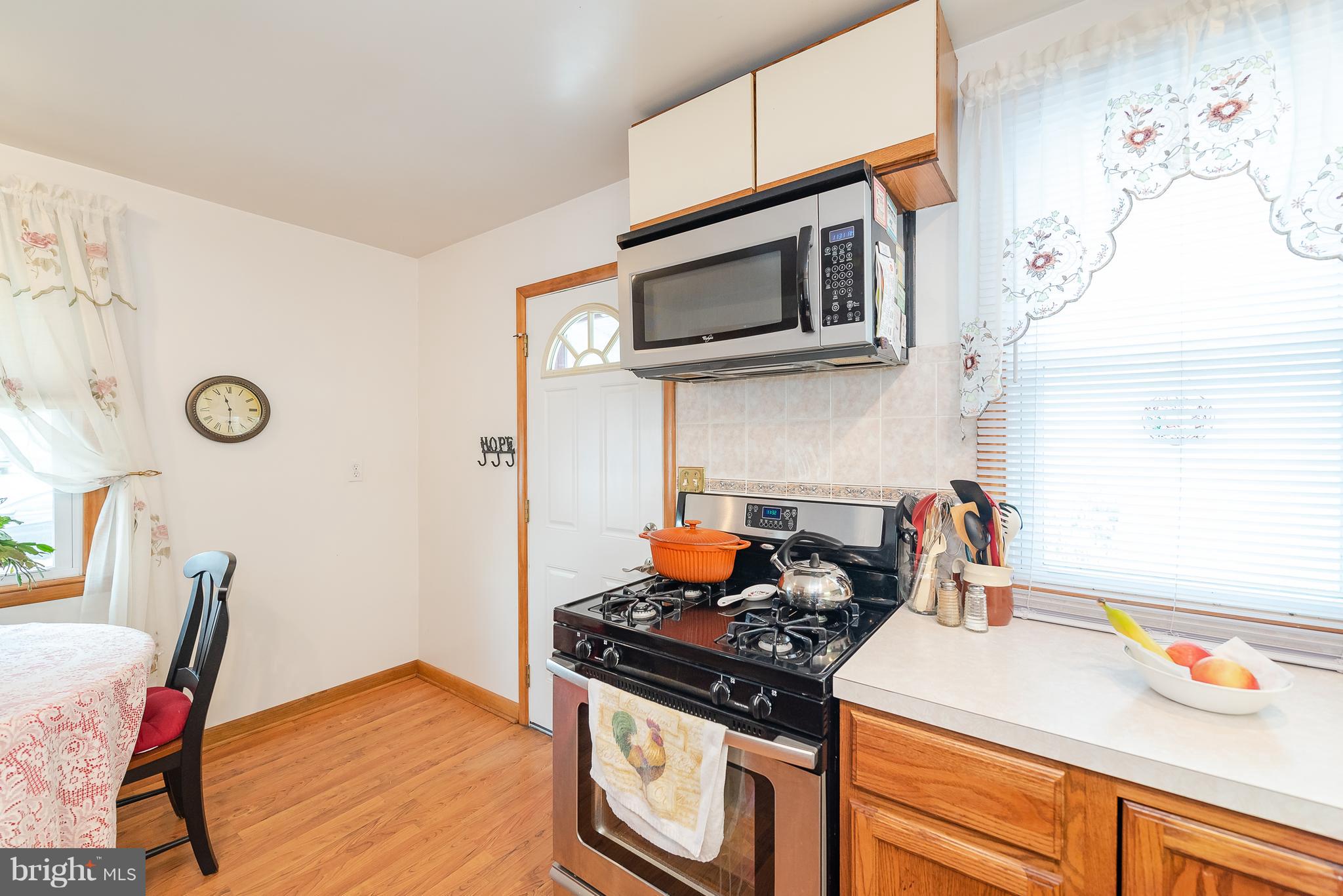 8238 Northview Road Baltimore, MD 21222 - Photo 28 of 42 a kitchen with stainless steel appliances a stove a microwave and cabinets