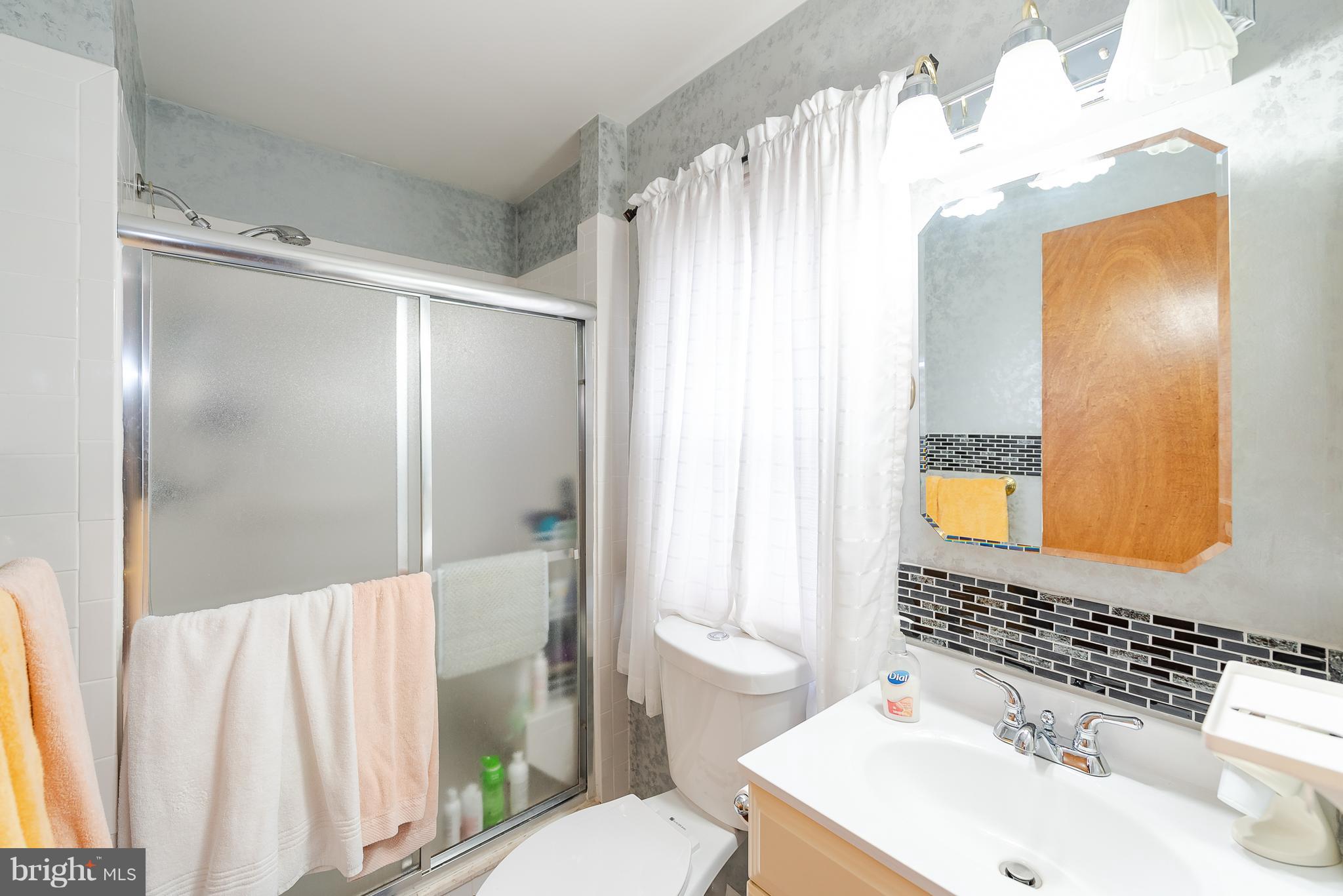 8238 Northview Road Baltimore, MD 21222 - Photo 29 of 42 a bathroom with a sink toilet and shower