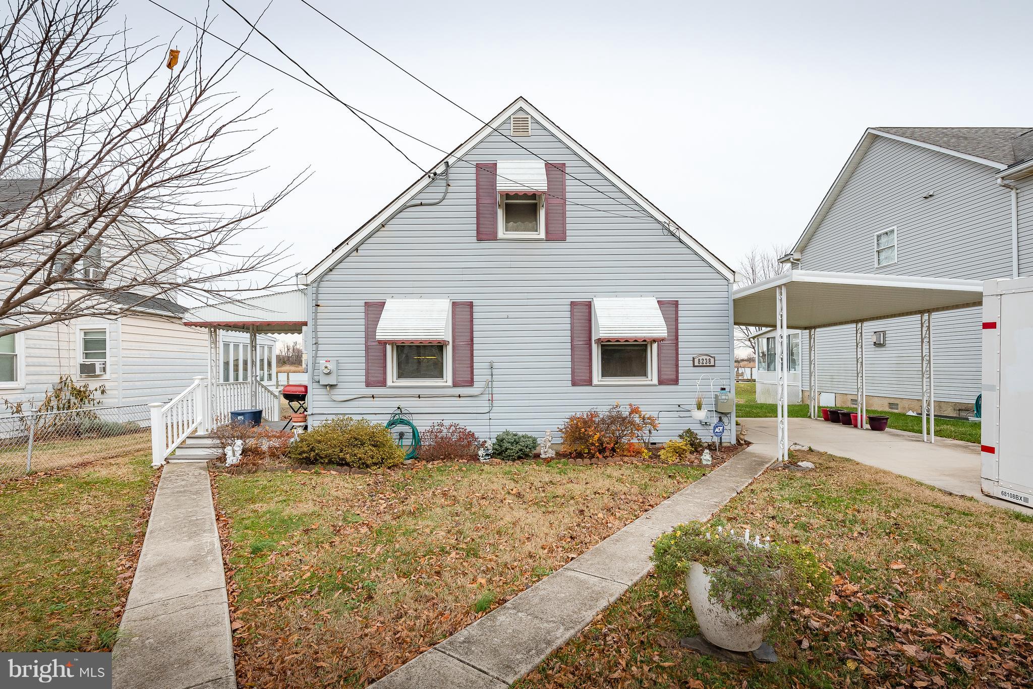 8238 Northview Road Baltimore, MD 21222 - Photo 4 of 42 a front view of a house with a yard and potted plants