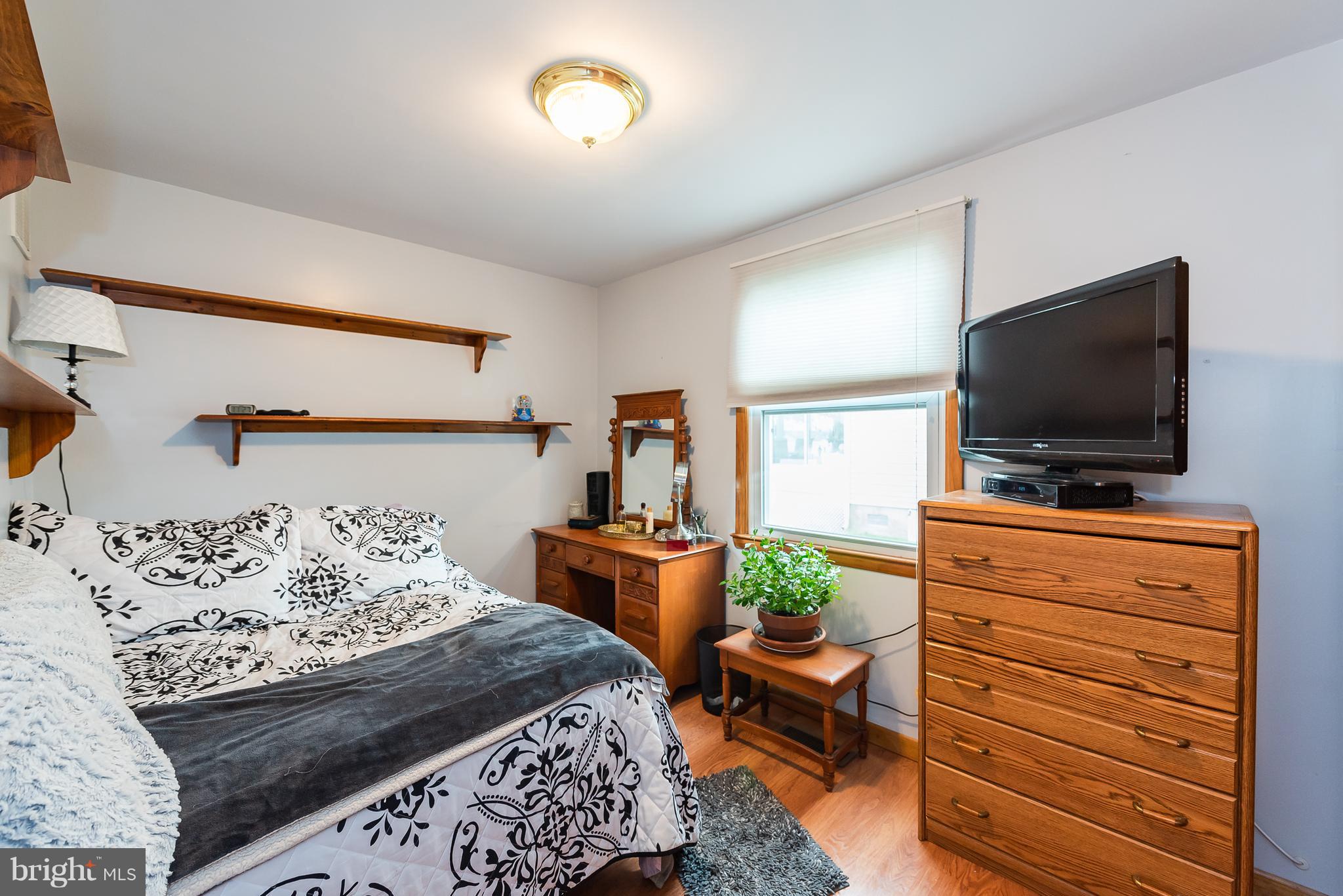 8238 Northview Road Baltimore, MD 21222 - Photo 36 of 42 a bedroom with a bed and a flat screen tv