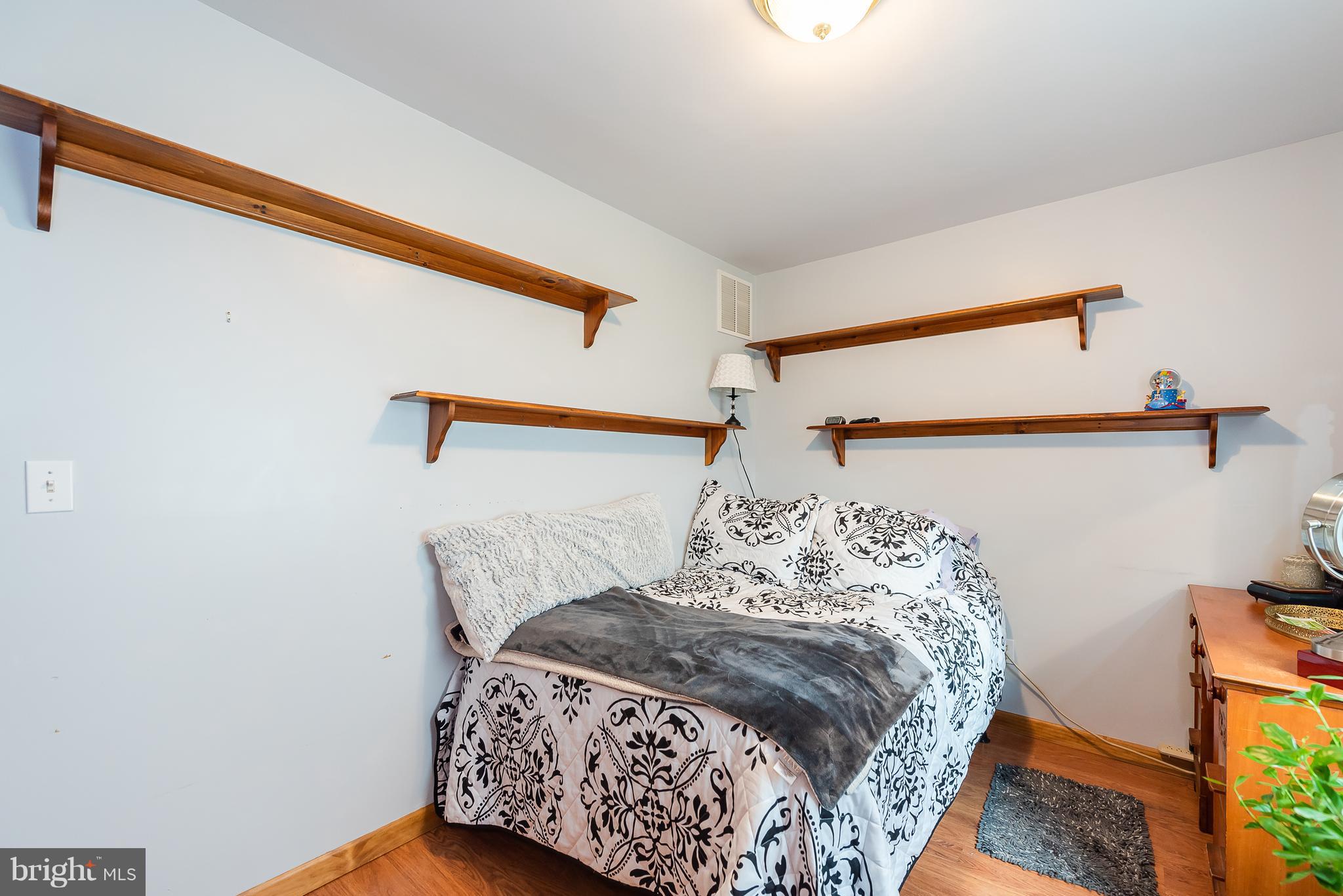 8238 Northview Road Baltimore, MD 21222 - Photo 38 of 42 a bed sitting in a bedroom next to a window
