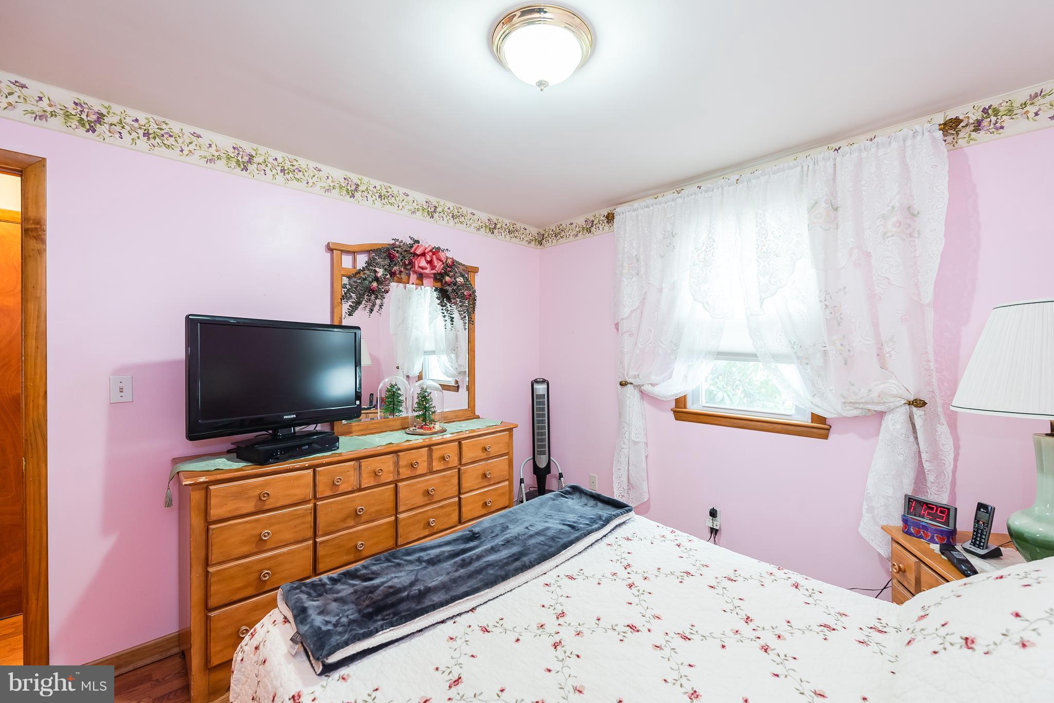 8238 Northview Road Baltimore, MD 21222 - Photo 41 of 42 a bedroom with a bed and a flat screen tv