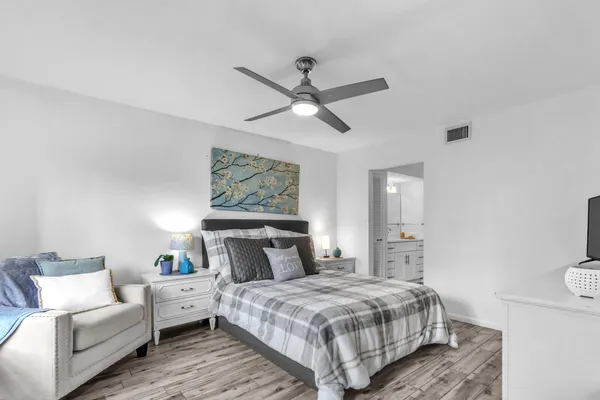 a bedroom with a bed and flat screen tv