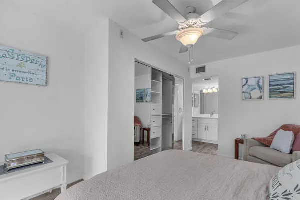 a bathroom with a sink a large mirror and a light fixture