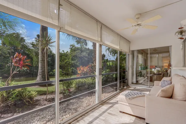 a front view of a house with a garden and trees
