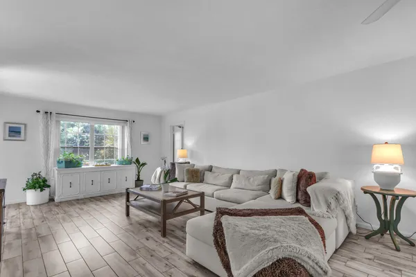 a living room with furniture and a large window