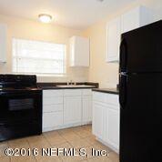 10437 Rutgers Road Jacksonville, FL 32218 - Photo 11 of 11 a kitchen with a refrigerator and a stove
