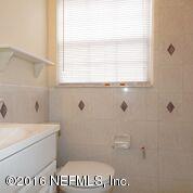 10437 Rutgers Road Jacksonville, FL 32218 - Photo 2 of 11 a bathroom with a sink a toilet and a window
