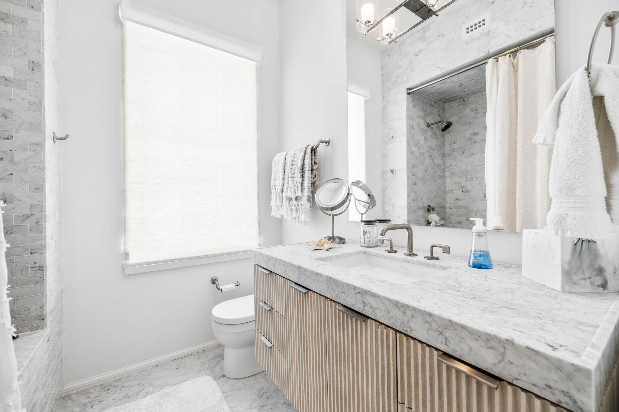 161 Catnap Alley Inlet Beach, Unit M6 Inlet Beach, FL 32461 - Photo 29 of 88 a bathroom with a granite countertop sink a toilet and a mirror