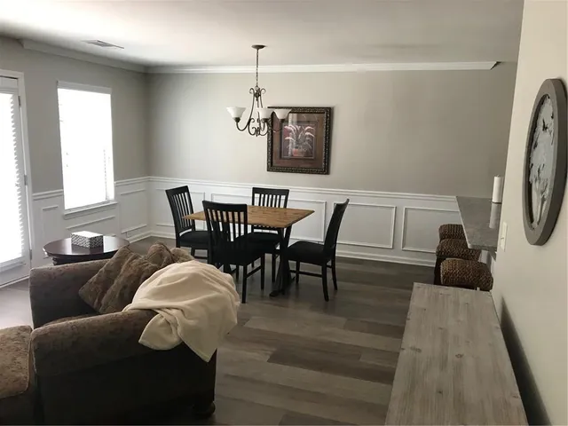 a view of a dining room with furniture and wooden floor
