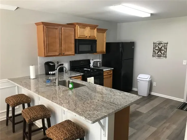 a kitchen with a granite countertop sink and stove