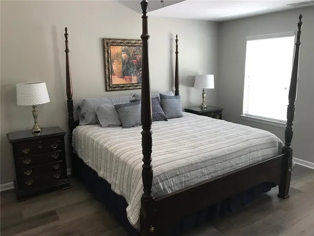 a bedroom with a bed and a lamp