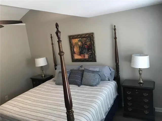 a bedroom with a bed and a lamp