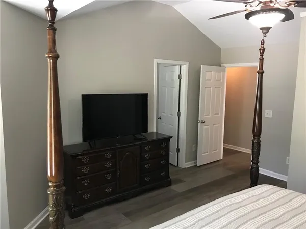 a room with a flat screen tv and a mirror
