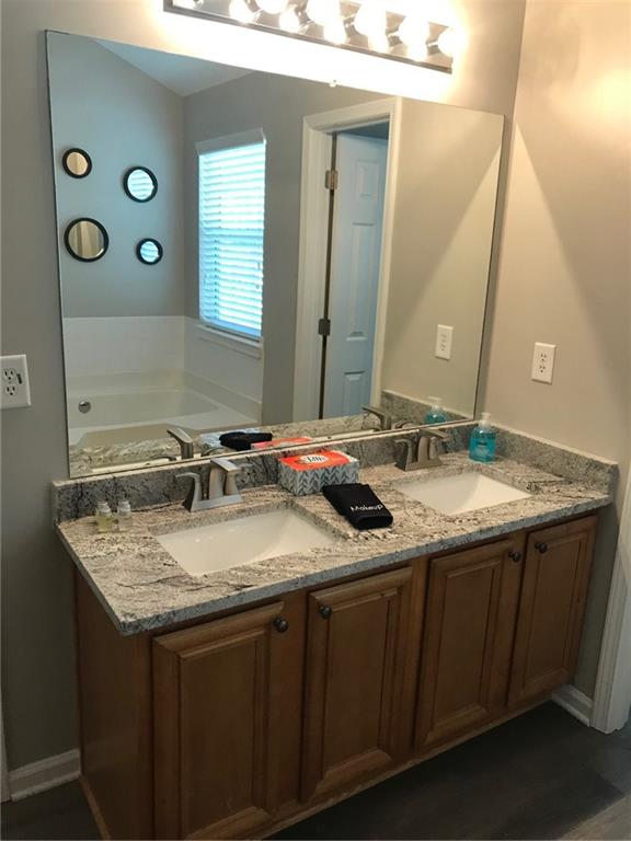 322 Hidden Creek Lane Canton, GA 30114 - Photo 20 of 44 a bathroom with a granite countertop sink and a mirror