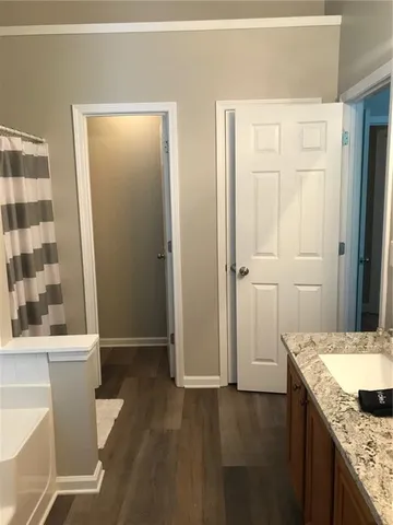 a bathroom with a granite countertop sink toilet and shower