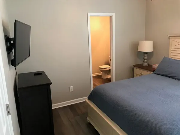 a bedroom with a bed and teddy bear on it