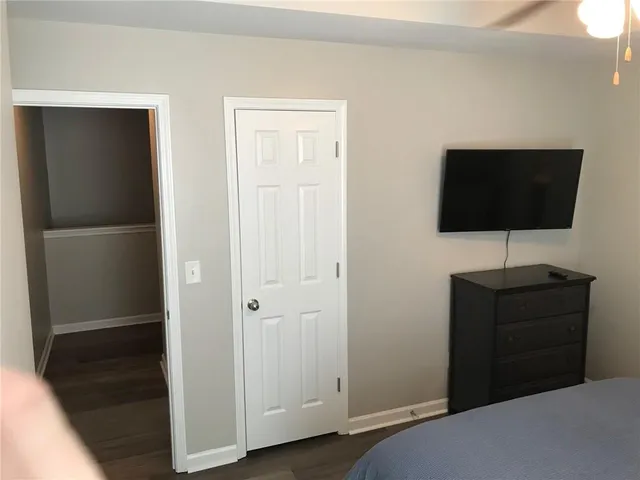 a bedroom with a bed and a flat screen tv