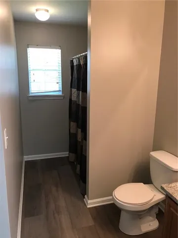 a bathroom with a toilet and a shower