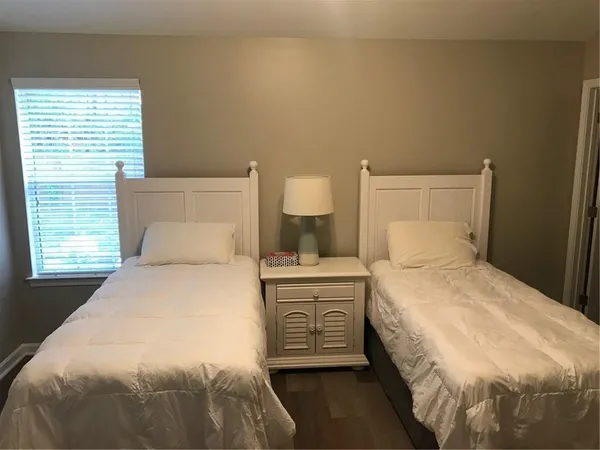 a bedroom with a bed and a night stand
