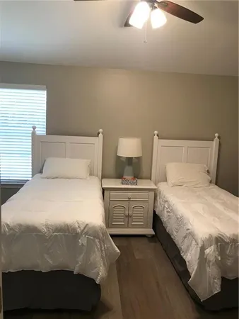 a bedroom with a bed and a night stand
