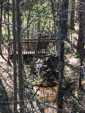 a view of a wooden deck with a yard