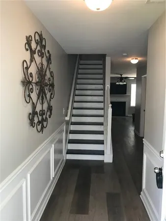 a view of entryway and hall with wooden floor
