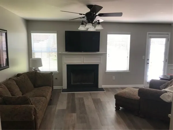 a living room with furniture a flat screen tv and a fireplace