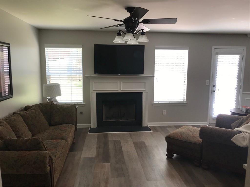 322 Hidden Creek Lane Canton, GA 30114 - Photo 7 of 44 a living room with furniture a flat screen tv and a fireplace