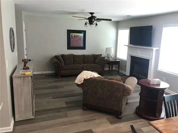 a living room with furniture a fireplace and a flat screen tv