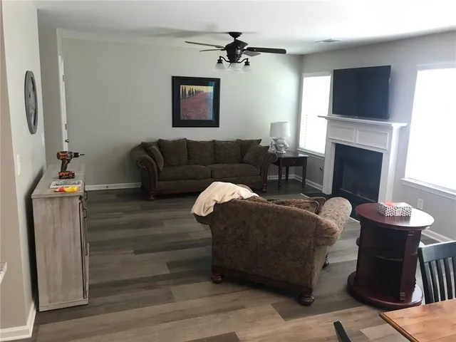 a living room with furniture a fireplace and a flat screen tv