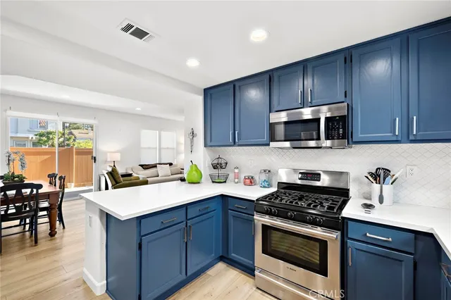 a kitchen with a sink stove top oven and cabinets
