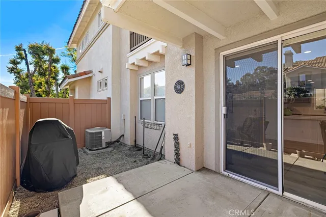 a living room with a large window and furniture