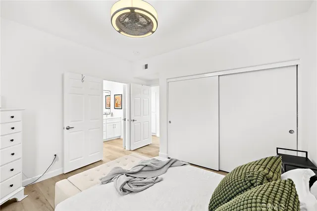 a bedroom with a bed and a chandelier